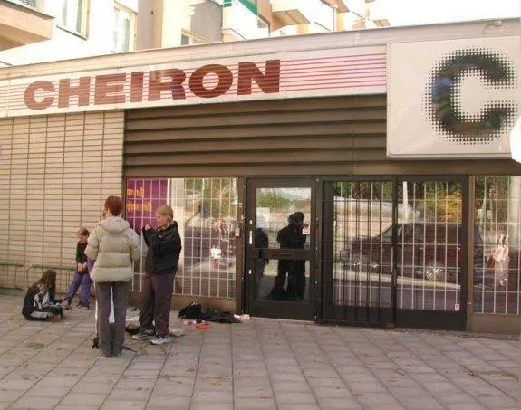 Small group of young fans standing outside Cheiron Studios beneath the red studio name and circular logo on the Kungsholmen facade in 2000.