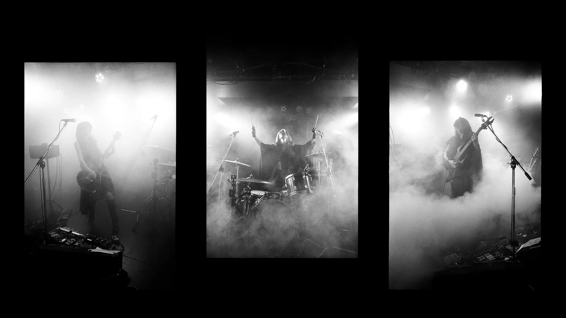 A side view of Boris performing through haze, with a large gong and stacked amplifiers visible onstage.