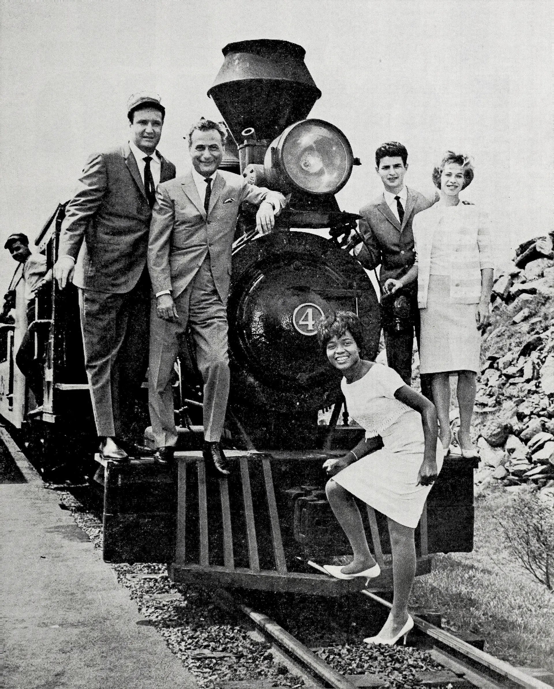 Cash Box magazine cover from 1962 showing Don Kirshner, Al Nevins, Little Eva, Gerry Goffin, and Carole King posed around a miniature locomotive.