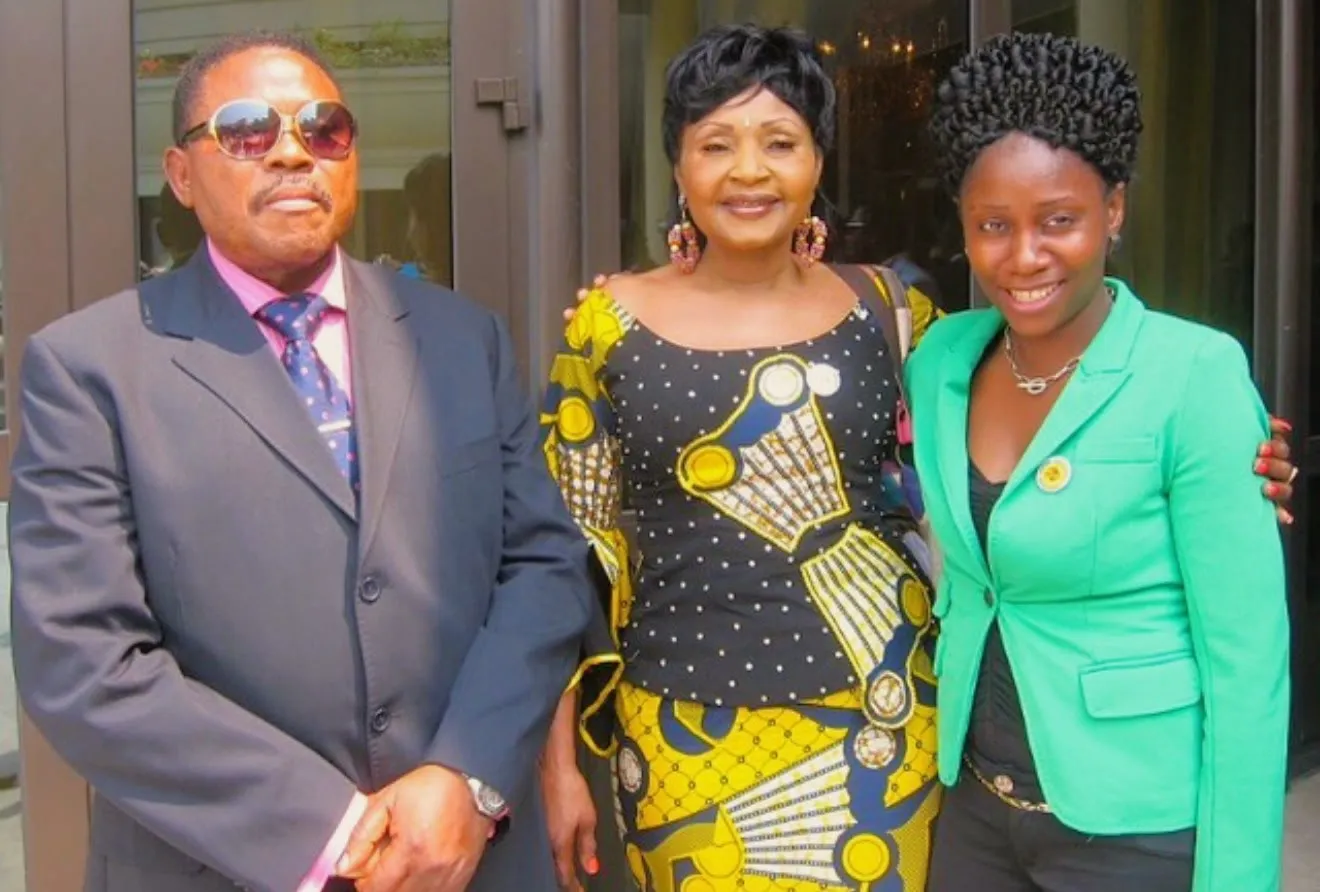 Verckys Kiamuangana Mateta, singer Mbilia Bel, and a woman in a green jacket pose together outside a building in 2019.