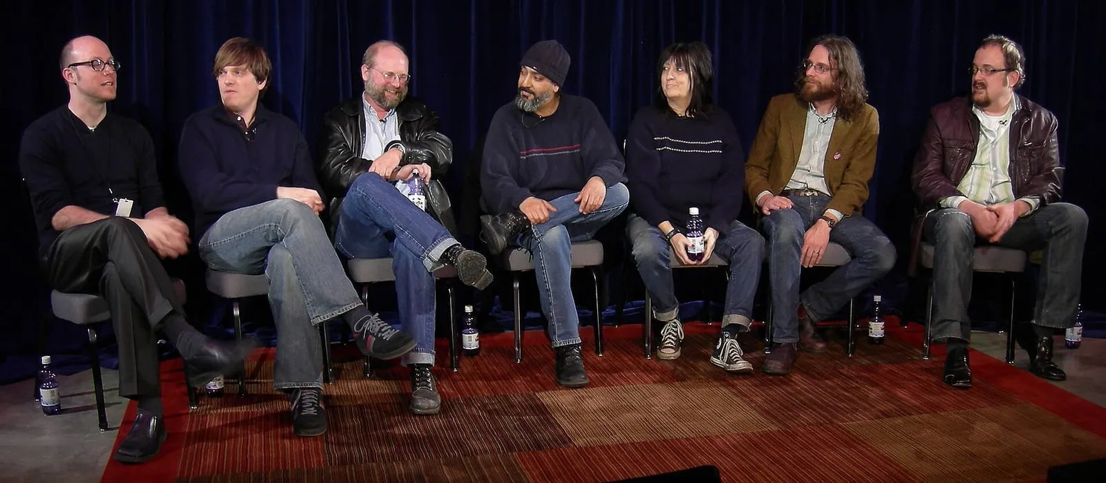A second view of a panel with Seattle musicians, a producer, and a graphic designer seated before an audience.