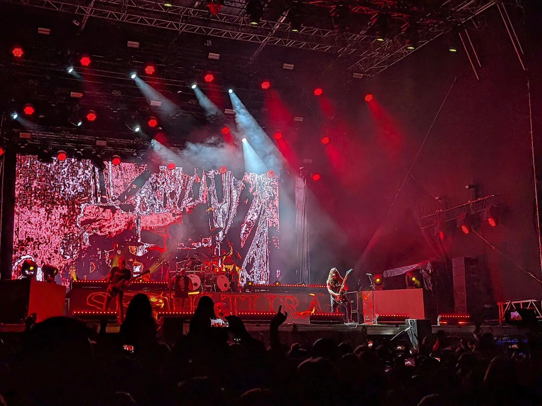 Sepultura performing as a full band under red stage lighting at Rockstadt Extreme Fest in 2025.
