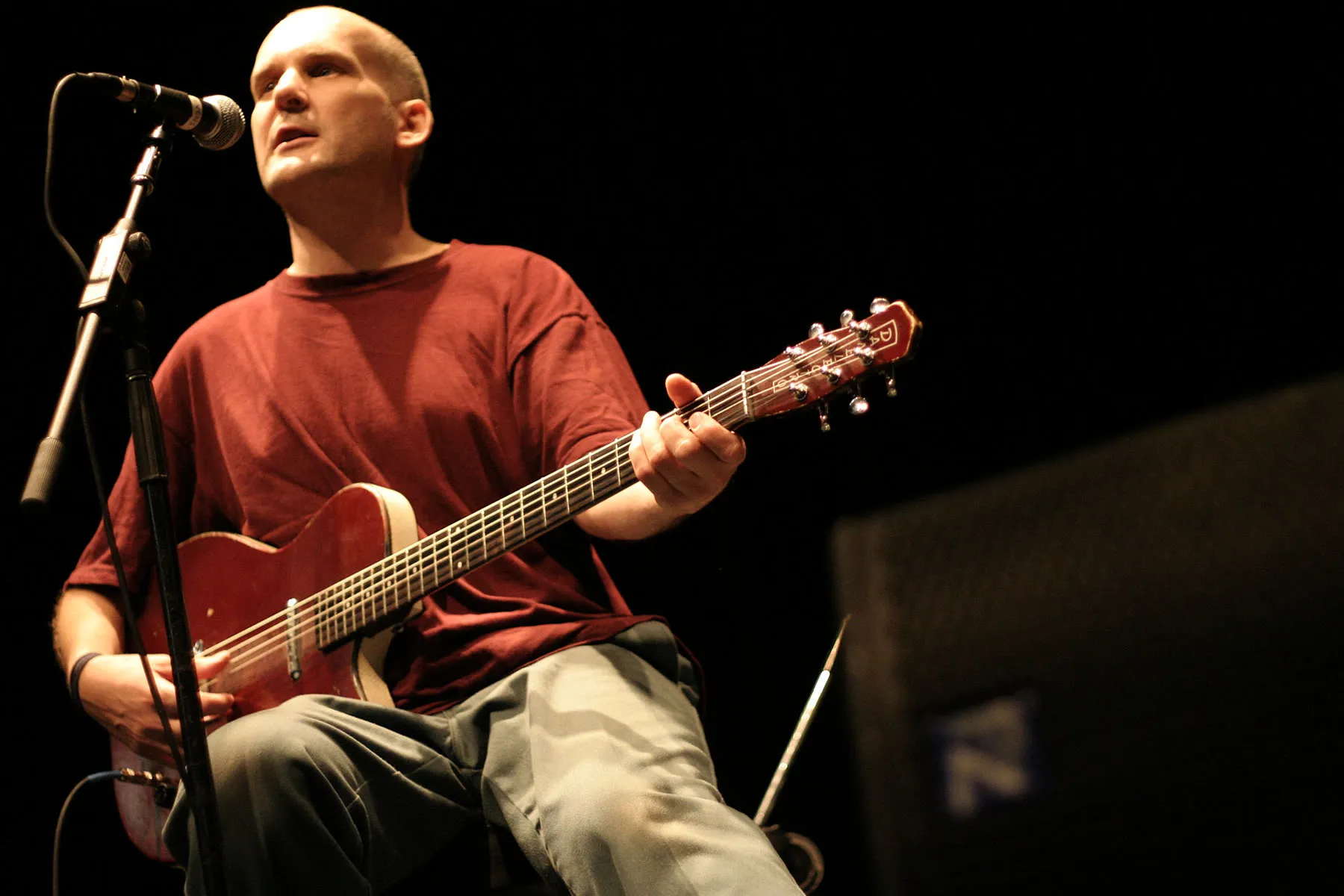 Ian MacKaye playing baritone guitar with the Evens during a performance.