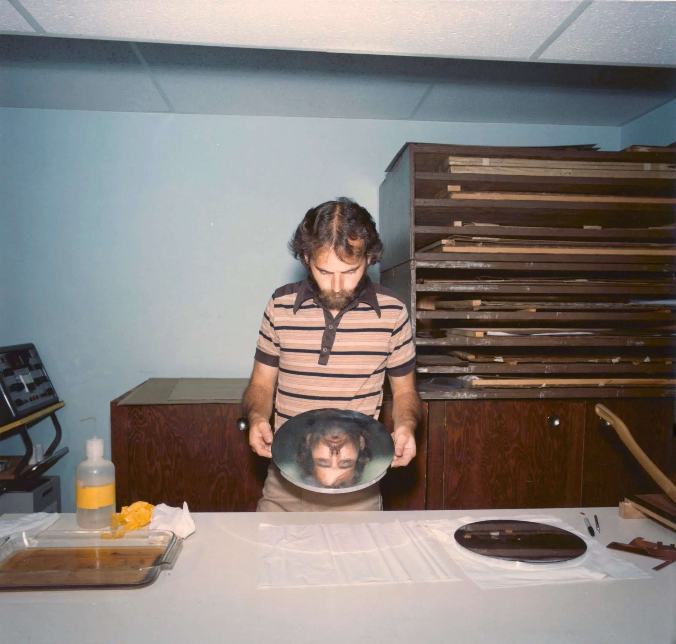 Archival photograph showing the Voyager Golden Record cover diagram being etched onto a metal surface during production in July 1977.